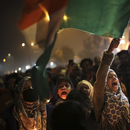 A girl waves the Indian flag as she shouts slogans at a protest site in the Shaheen Bagh neighbourhood of New Delhi on January 21. Photo: AP