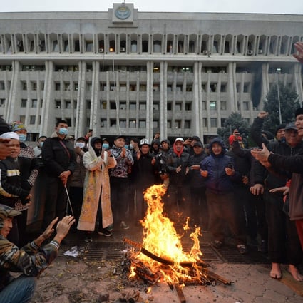 People protesting the results of a parliamentary vote gather by a bonfire in front of the seized main government building, known as the White House, in Bishkek, Kyrgyzstan, on October 6. Photo: AFP