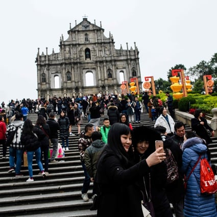 Tourists throng the southern facade of the ruins of St Paul’s Church in Macau in February 2018. The Portuguese presence in Asia is one of the longest from the Western countries, spanning over five centuries. It became the last to leave the continent with the consensual return of the sovereignty of Macau in 1999. Photo: AFP