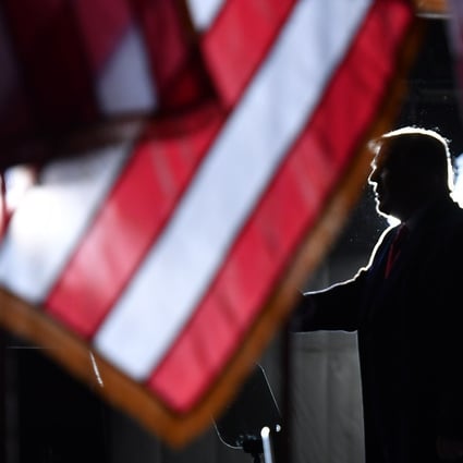 US President Donald Trump is seen behind US flags as he speaks to supporters in Wisconsin on September 17. Photo: AFP