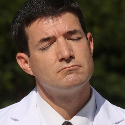 White House doctor Sean Conley closes his eyes as he looks into the sun during a news conference about US President Donald Trump’s health on Monday. Photo: Reuters