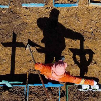A gravedigger stands at the Nossa Senhora Aparecida cemetery where Covid-19 victims are buried daily, in Manaus, Brazil in June. Photo: AFP