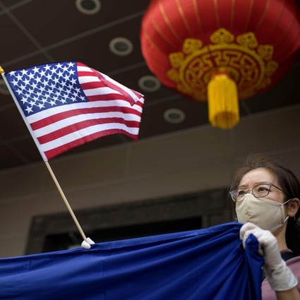 A protester holds a US flag outside of the Chinese consulate in Houston on July 24, after the State Department ordered China to close the consulate. Photo: AFP