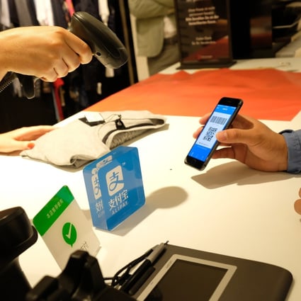 A customer using Alibaba's Alipay electronic payment service at the Breuninger store in Dusseldorf, Germany, on June 29, 2018. Photo: Xinhua