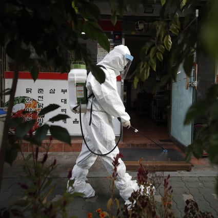 A South Korean health worker sprays disinfectant in Seoul. Photo: AP
