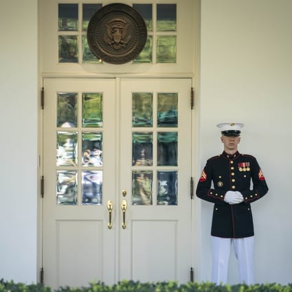 A member of the US Marines is posted at the West Wing door of the White House, an indication that President Donald Trump is in the Oval Office. Photo: Reuters