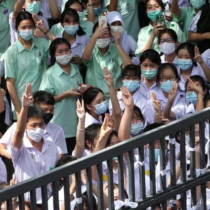 Thai students flash the three-finger salute during an anti-government protest at a school in Bangkok on October 2. Pupils are calling for an end to bullying and harassment in schools, and other education reforms. Photo: EPA-EFE