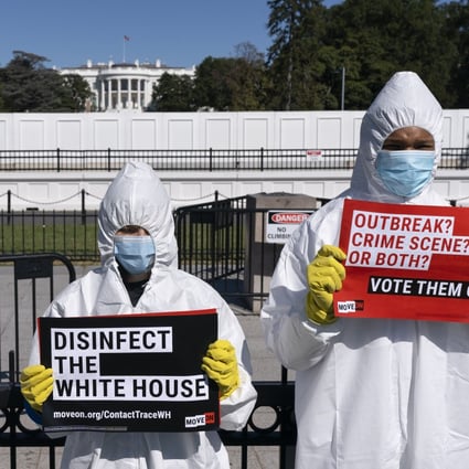 Wearing protective suits, masks and gloves, demonstrators call attention to the outbreak of coronavirus in the White House. Photo: AP