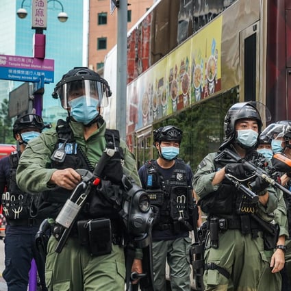 Riot police armed with pepper spray canisters stand guard during a protest in Hong Kong. Photo: Bloomberg