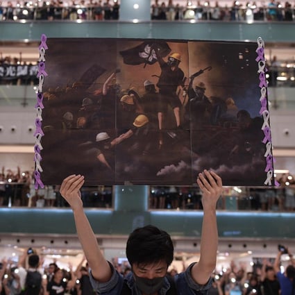 A protester holds up a poster during a rally at a Sha Tin shopping mall on September 11 last year in a photo nominated for this year’s World Press Photo contest. Photo: AFP