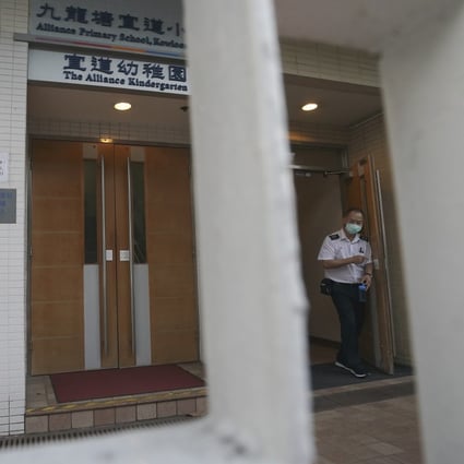 A security guard stands outside the Alliance Primary School in Kowloon Tong on Tuesday. Photo: Felix Wong