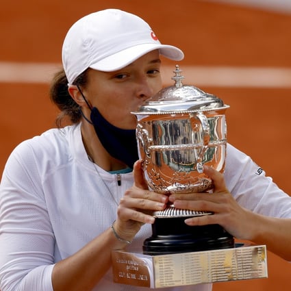 Iga Swiatek of Poland celebrates with the trophy after winning the French Open against Sofia Kenin of the USA. Photo: EPA