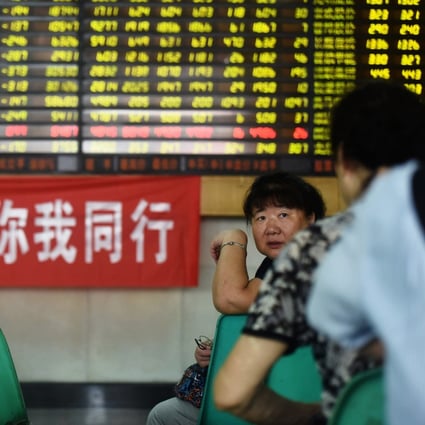 Stock investors chat in front of a giant scoreboard inside a Shanghai brokerage. Photo: Chinapix via AP
