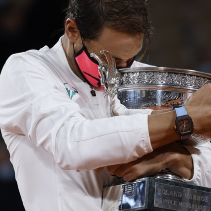 Rafael Nadal holds his trophy after winning against Novak Djokovic in their French Open men’s final in Paris on Sunday. Photo: EPA-EFE