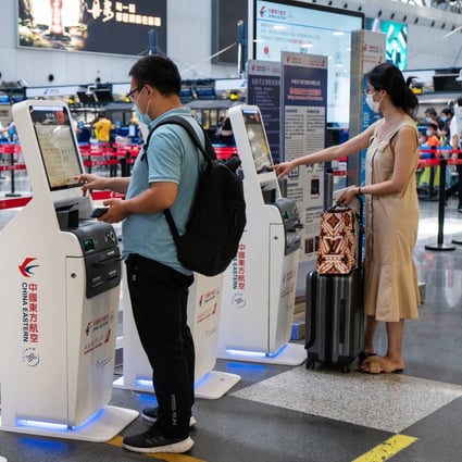 Travellers checking in at China Eastern Airlines' self check-in kiosks at Beijing Capital International Airport on Tuesday, August 25, 2020. Photo: Bloomberg