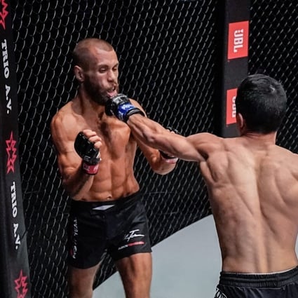 Reece McLaren lands a punch flush on Aleksi Toivonon's chin at ONE: Reign of Dynasties in Singapore. Photos: ONE Championship