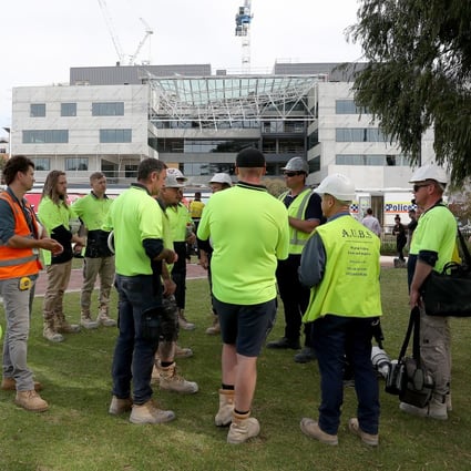 Construction workers gather at the scene of a collapsed building at Curtin University in Perth, Australia. Photo: EPA