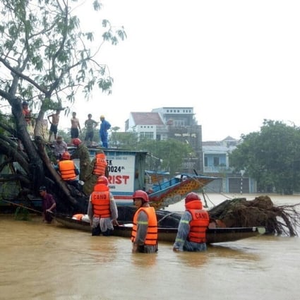 Officials evacuate residents from Hue, Vietnam after heavy rains caused flooding. Photo: EPA