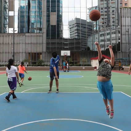 People play basketball at a public court in Quarry Bay on October 2, as gathering limits were relaxed for team sports at non-fee-charging outdoor leisure venues. Photo: Xiaomei Chen