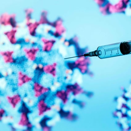 A syringe is pictured on an illustration representing the coronavirus that causes Covid-19. Photo: AFP