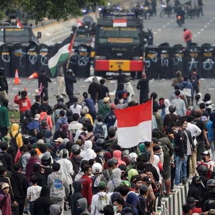 Demonstrators gather in front of police in Jakarta in ongoing protests against Indonesia’s new jobs creation law. Photo: Reuters
