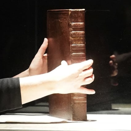 A Christie's employee holds a rare first folio of 36 Shakespeare works in New York on Wednesday. Photo: Reuters