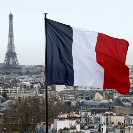 The French flag flies in Paris, with the Eiffel Tower in the background. France’s government is facing criticism at home over its coronavirus strategy. Photo: Reuters