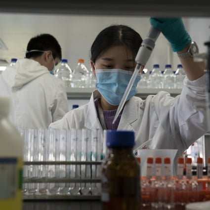 A SinoVac lab employee works at a factory producing its Sars-CoV-2 vaccine in Beijing on September 24. Plans to rely on herd immunity to contain the spread of Covid-19 would require more than 5 billion people worldwide to have had the infection before it would take effect. Photo: AP