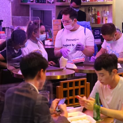 Staff of Hong Kong-based testing agency Prenetics visit Lan Kwai Fong in Central on October 9 to distribute Covid-19 test packs to customers in response to a potential fourth wave of coronavirus infections in the city. The economic impact of the government’s anti-pandemic measures has led some people to propose pursuing a herd immunity strategy instead and moving towards a more business-friendly approach. Photo: Dickson Lee