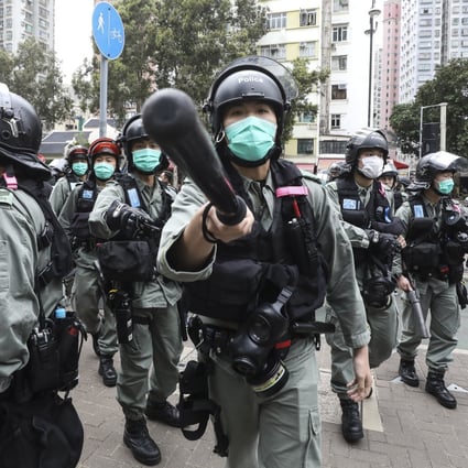 Riot police disperse protesters and media in the Tai Po area of Hong Kong in March. Photo: Dickson Lee