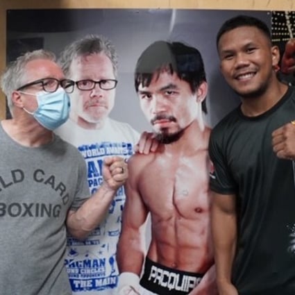 Freddie Roach and Eumir Marcial pose in front of a picture of Roach with Manny Pacquiao at the Wild Card Boxing Club in Hollywood, California. Photo: MP Promotions