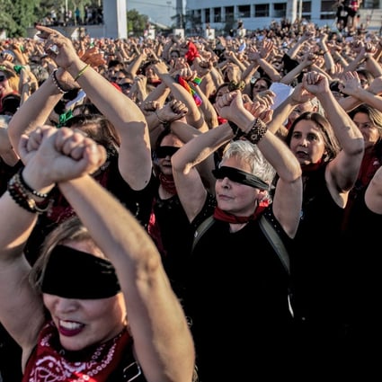 Thousands of women’s rights activists take part in a choreographed performance of the feminist song, “The rapist is you”, in Santiago, Chile on December 04, 2019. Photo: AFP via Getty Images