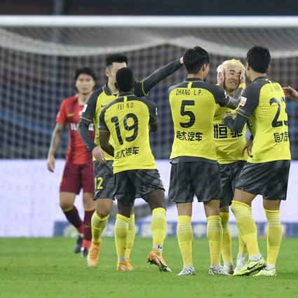 Wei Shihao (centre) celebrates his goal with Guangzhou Evergrande teammates in the Chinese Super League match against Hebei China Fortune. Photo: Xinhua