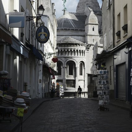 Tourists shops are empty in a deserted street outside the Sacre Coeur basilica in the Montmartre district of Paris. Photo: AP