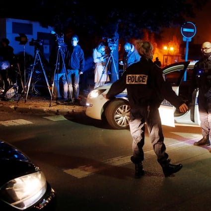 Police officers secure the area near the scene of a stabbing attack in the Paris suburb of Conflans St Honorine. Photo: Reuters