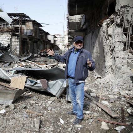 A man in the yard of his apartment building, destroyed by shelling by Azerbaijan’s artillery, in Stepanakert, in Nagorno-Karabakh, on October 10. Photo: AP