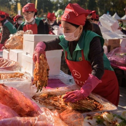 Volunteers take part in a kimchi making festival in Seoul in 2018. File photo: AFP