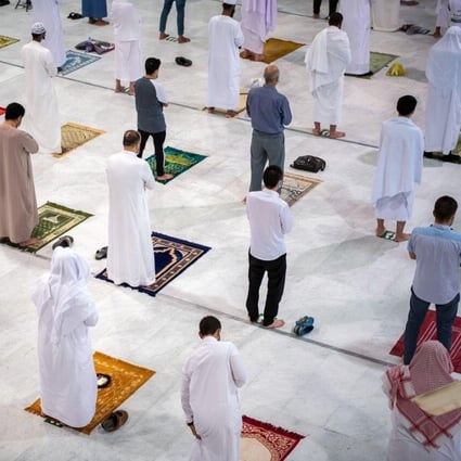 Muslims maintaining social distancing pray in the Grand Mosque on Sunday for the first time in months since the coronavirus restrictions were imposed. Photo: Saudi Press Agency handout via Reuters
