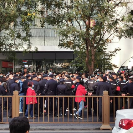 Some 200 people gathered outside the office of Youwin Education in Beijing demanding refunds after the company collapsed. Photo: Frank Tang