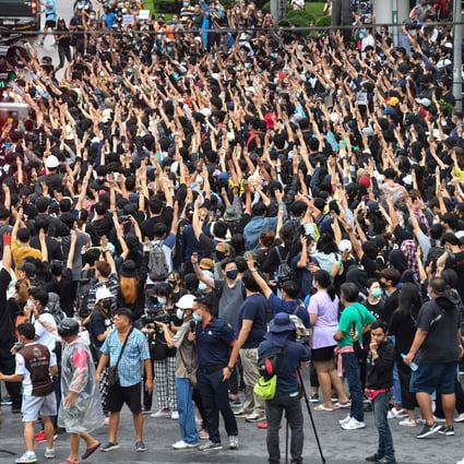 Pro-democracy protesters give the three-finger salute at Wongwian Yai during an anti-government rally in Bangkok on Saturday. Photo: AFP