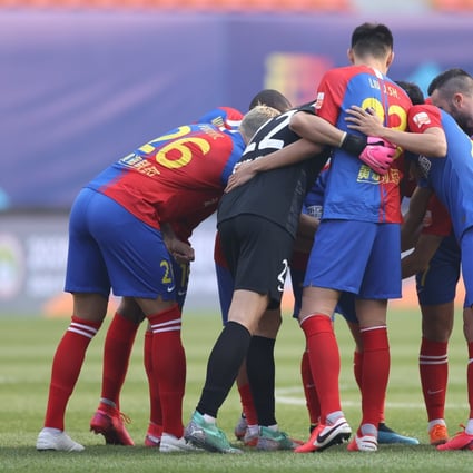 Qingdao Huanghai players prepare for their game against Guangzhou R&F in the Chinese Super League in Dalian. Photo: Xinhua