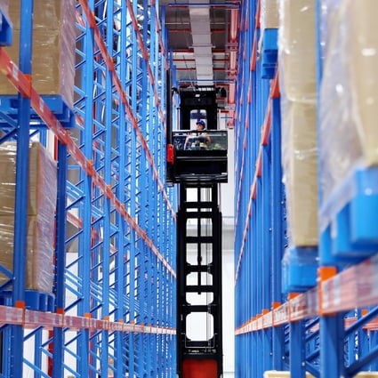 A member of staff works between storage shelves at a logistics centre in Shanghai on June 5. The trade war and Covid-19 have merely accelerated the long-term trend of supply chain reconfiguration. Photo: Xinhua