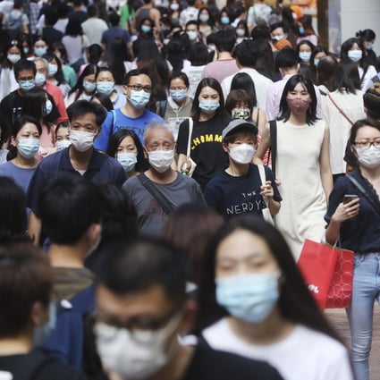 Shoppers crowd the streets in Causeway Bay on Sunday as the social-distancing rules against coronavirus relax. Photo: Edmond So