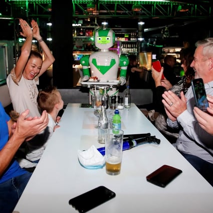 A robot delivers a birthday cake at Robotazia restaurant as the coronavirus outbreak continues in Milton Keynes, Britain, October 2, 2020. Photo: Reuters