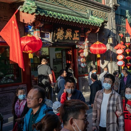 Pedestrians walk through the Qianmen area of Beijing on October 4, during the Golden Week holiday. China is the only major economy expected to post positive economic growth in 2020. Photo: Bloomberg