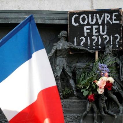 A placard placed on the Republique statue in Paris on October 18 questions the French government’s controversial imposition of an overnight curfew after a rise in Covid-19 infections. Photo: Reuters