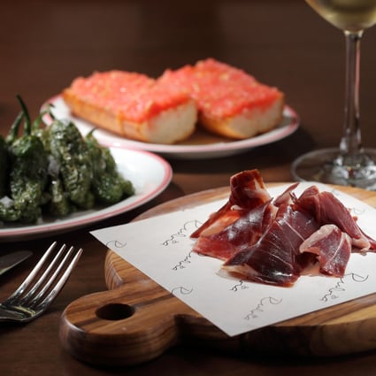 Iberico ham, Padrón peppers and tomato bread at Rubia. Photo: Alex Chan