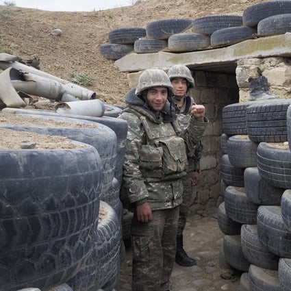 Ethnic Armenian soldiers stand guard in a frontline trench against Azerbaijan's armed forces. Photo: AP