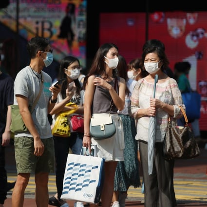 Pedestrians in masks cross the street in Causeway Bay. Photo: Xiaomei Chen