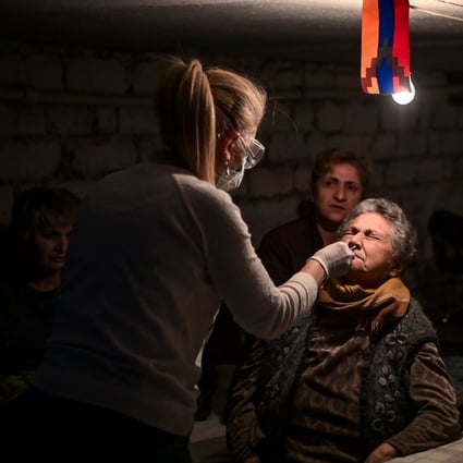 A doctor swabs an elderly woman as she administers a Covid-19 test in the city of Stepanakert on Friday. Photo: AFP